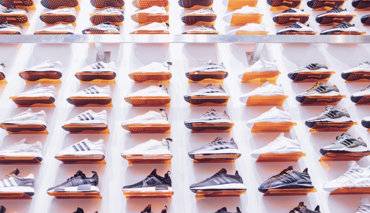 A display of Foot Locker sneakers is shown on a white wall