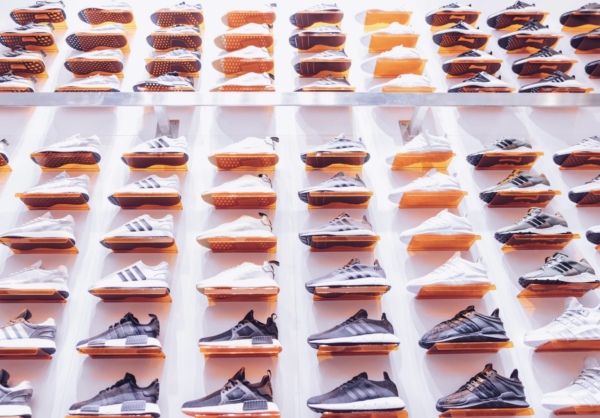 A display of Foot Locker sneakers is shown on a white wall