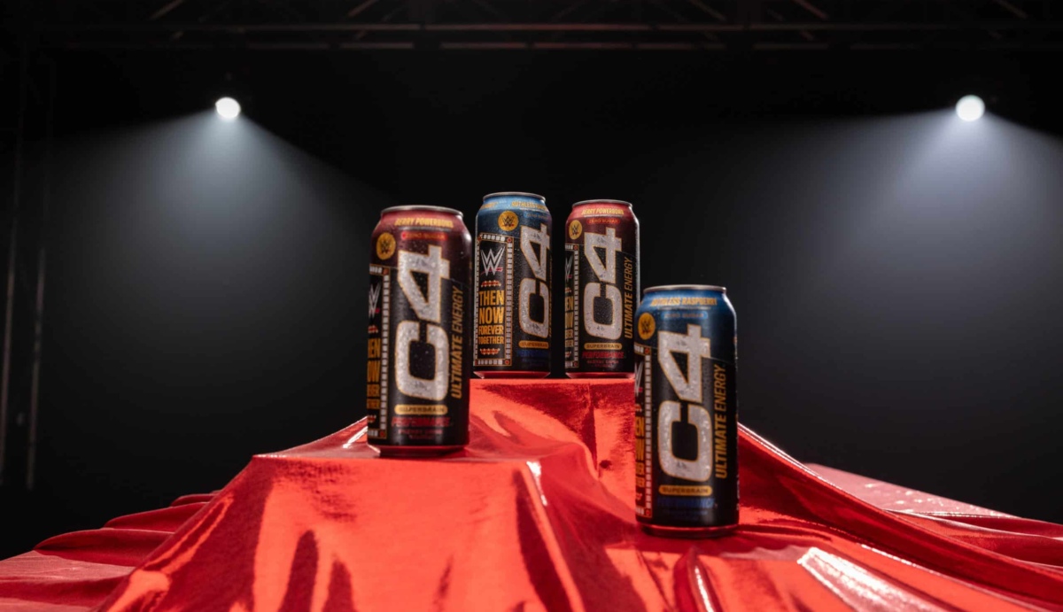 C4 Ultimate® x WWE® Product Launch Image shows C4 energy drink cans in a WWE ring with a red curtain draped below.